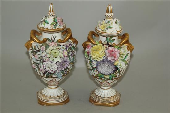 A pair of John Bevington floral encrusted twin handled vases, late 19th century, 24.5cm, damage to covers